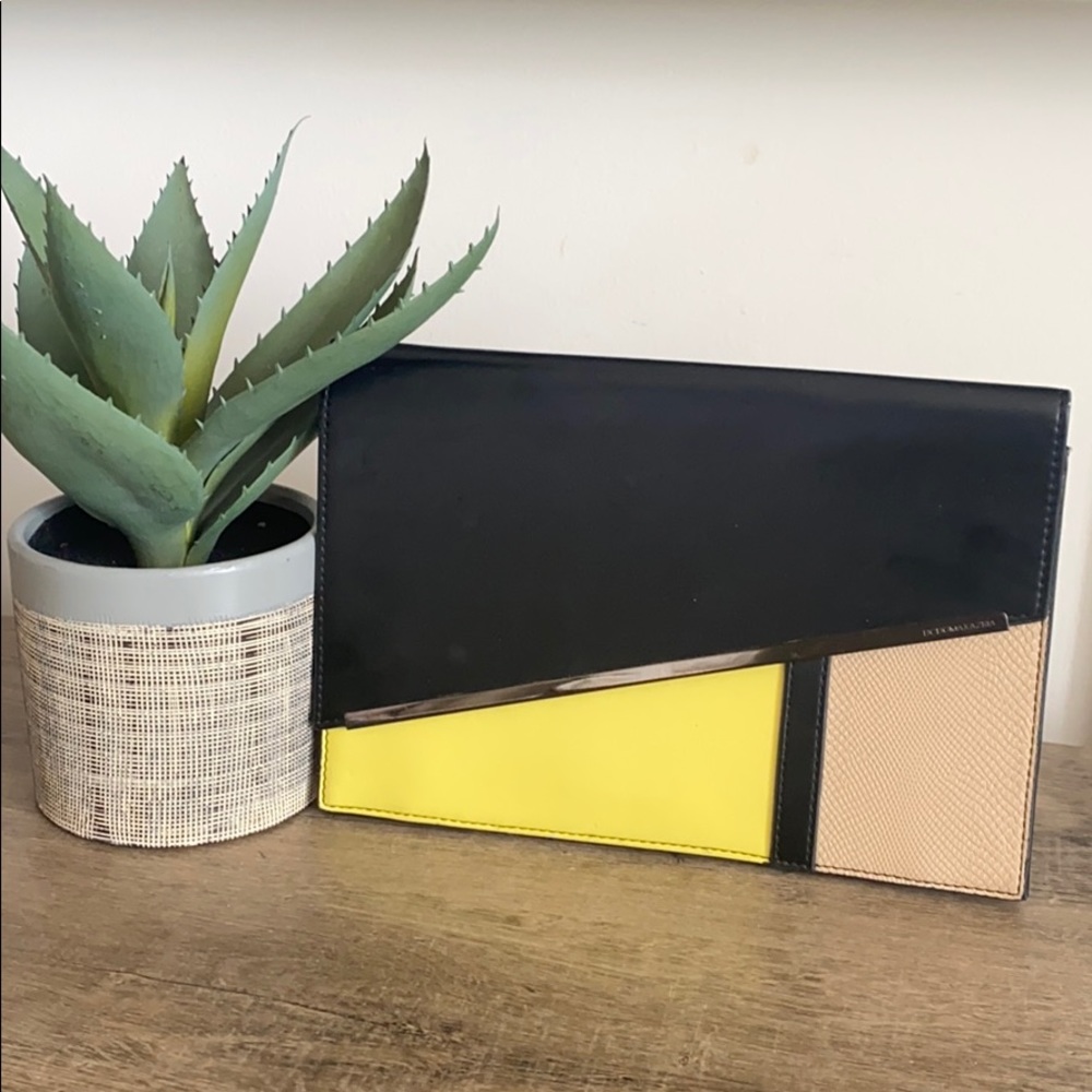 BCBG black, tan, yellow clutch